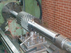 Double helical gear being cut in a lathe